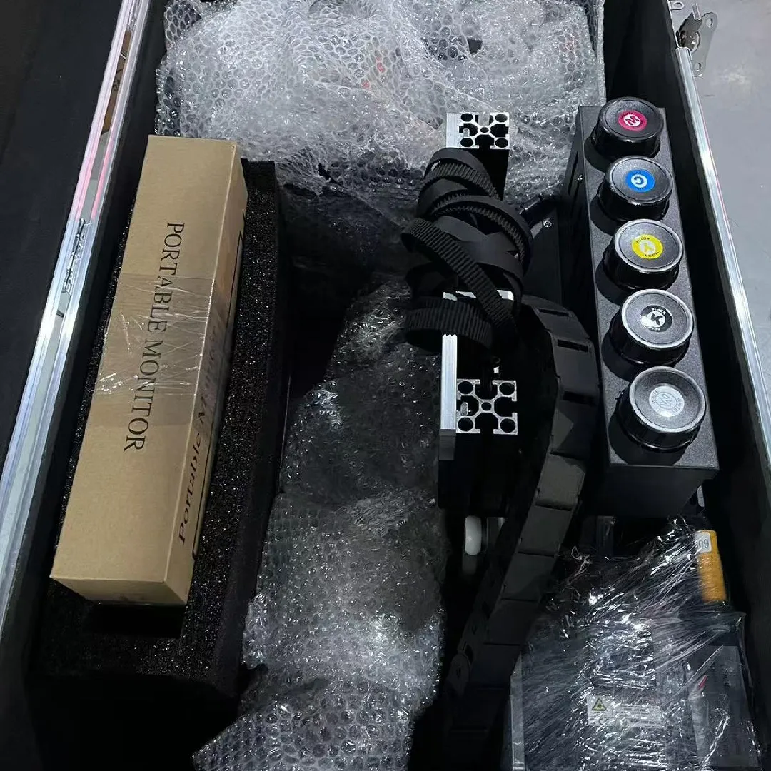 A labeled OEM wall printer sample on the packing bench — a V2 Pro chassis with a partner's logo silkscreened and a branded crate next to it